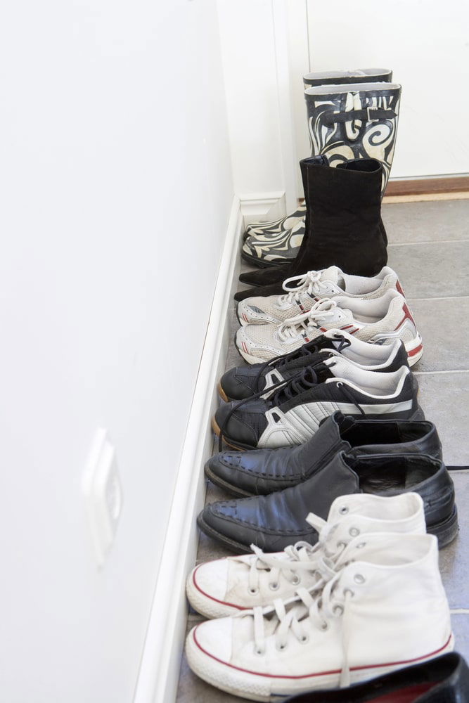 A group of shoes on the Turkish floor, reflecting the vibrant traditions and customs of Turkey of removing shoes before entering.